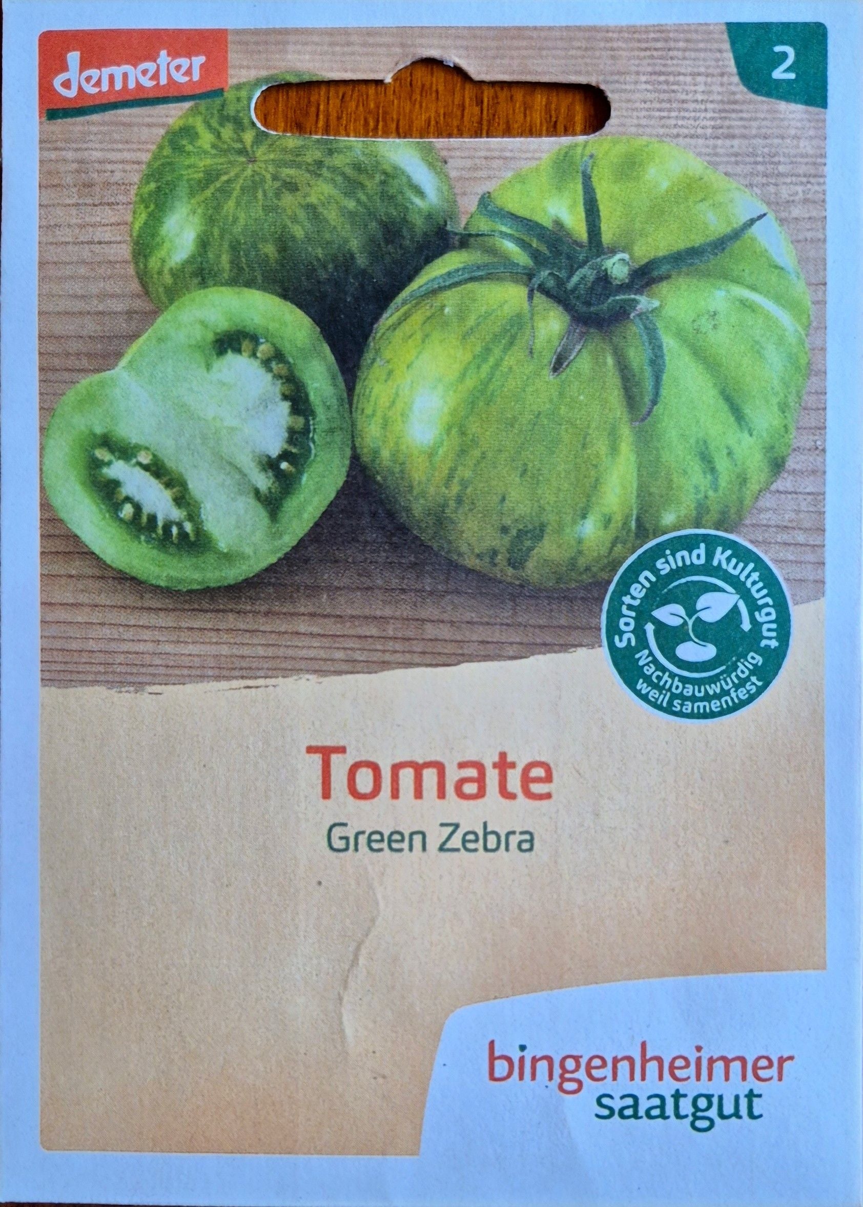 Vorderseite der Saatguttüte Bio-Tomate Green Zebra (Demeter) von Bingenheimer Saatgut mit Abbildung der grüngelb geflammten Tomaten.